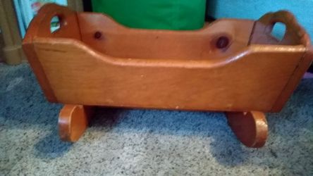Antique solid wood doll bassinet.