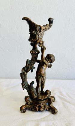 antique Rococo-style figural bronze candlestick featuring a cherub