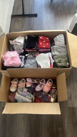 Box of girl clothes and shoes
