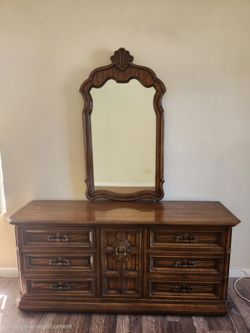 Traditional formal dark wood dresser with mirror.