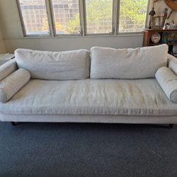 Gorgeous West Elm sofa with that signature mid-century modern look — light gray woven fabric, track arms, walnut tapered legs, and two included bolste
