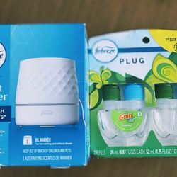 2 Fragrance Holders With Two Fragrance And It Equally One Black One White