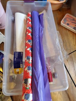 Construction Papers, gift wrapping paper, post board, purple table cloth, under bed storage bin