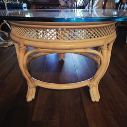 Vintage round rattan coffee table with a glass top, often styled as Coastal, Tiki, or Palm Beach Regency. 36"×17.5"
