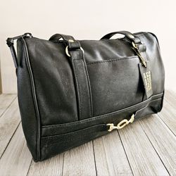 Black Leather Women's Handbag Shoulder Purse with Gold Buckle Accent, Exterior and Interior Pockets and Black Zippered Closure.

Measures 7"H x 11"L x