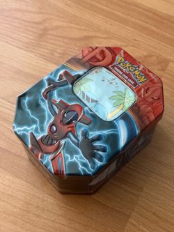 Free Pokemon tin with energies, some cards, an air freshener, dice, sleeves.