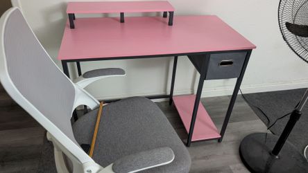 Pink desk with white chair combo.
