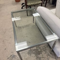  Cocktail  table with a stainless steel base and glass top  41” x 24” 