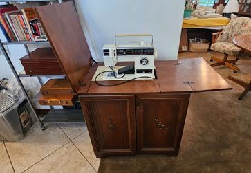 Singer sewing machine with cabinet.