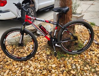 Red and black Genesis Two Nine mountain bike featuring 29-inch wheels and a lightweight alloy frame