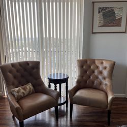 Beautiful leather Pottery Barn tufted back armchairs with nail head trim, low profile arms and mahogany colored legs. Originally over