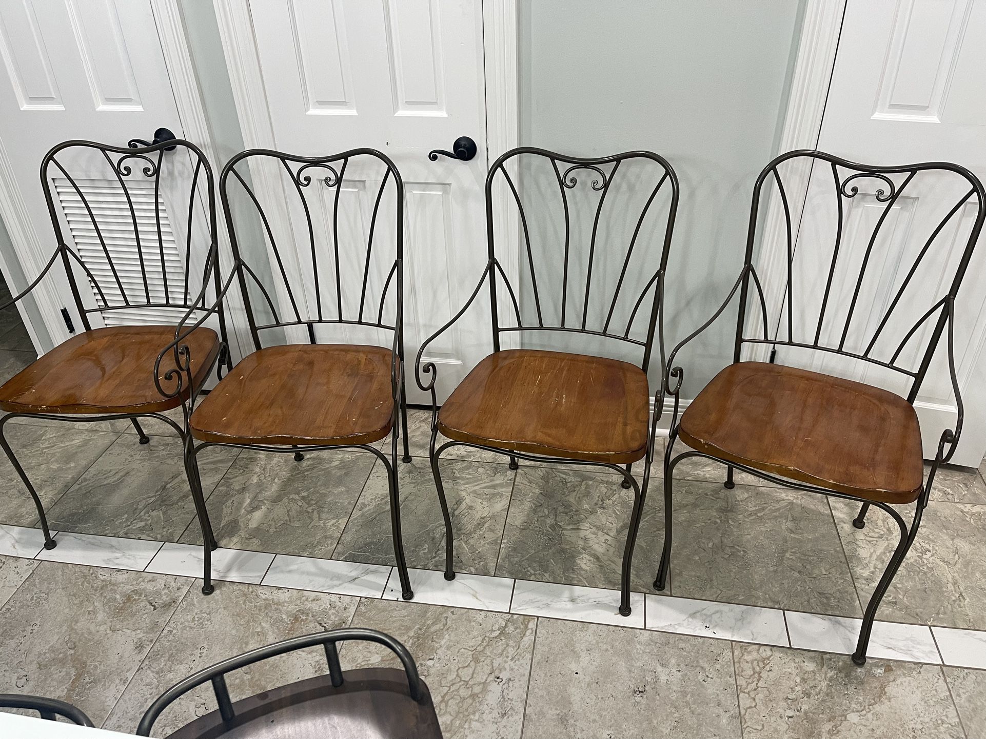 4 sturdy wood , heavy and solid metal Dinnig chairs in good condition one is super heavy