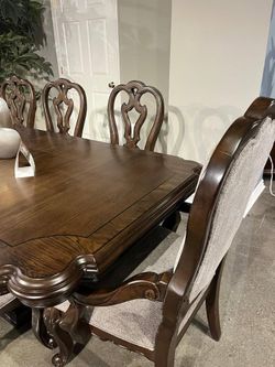 Brown finish dining set features large dining table w/2 extension leaf