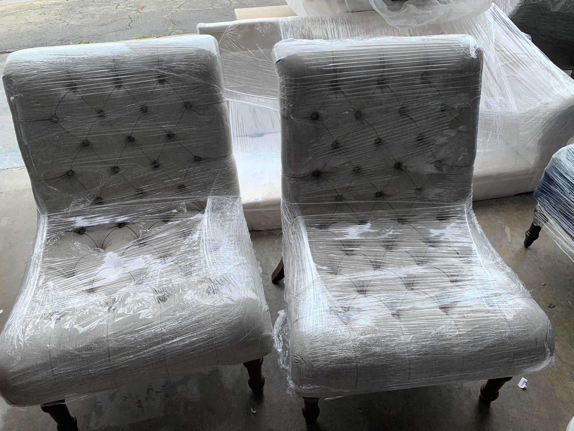 Pair of oatmeal tufted accent chairs