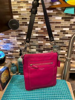 Coach Legacy Leather Swingpack crossbody in a vibrant pink color