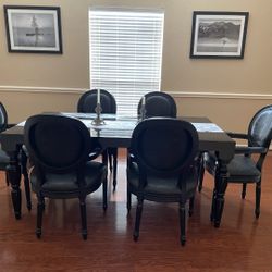 Modern baroque black lacquer dining-room table with crocodile pattern chairs