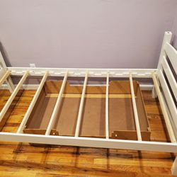 Twin size white bed frame with storage drawer on wheels