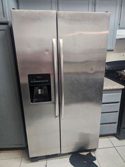 Amana Side-by-Side Stainless Refrigerator – Works Great, Needs Minor Drain Cleaning (Dented)