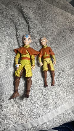 Avatar: The Last Airbender" Aang action figures from McFarlane Toys, likely a 7-inch scale figure and a smaller 5-inch version