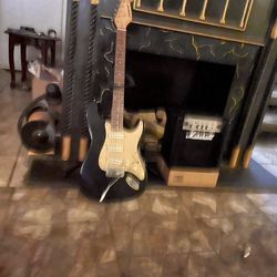 Package Deal , Amp And Guitar OBO , black and yellow in color .