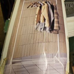 White, Never used, metal clothing rack with swing arm for extra storage.