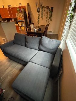Navy blue couch used Velcro on cushions to stay in place