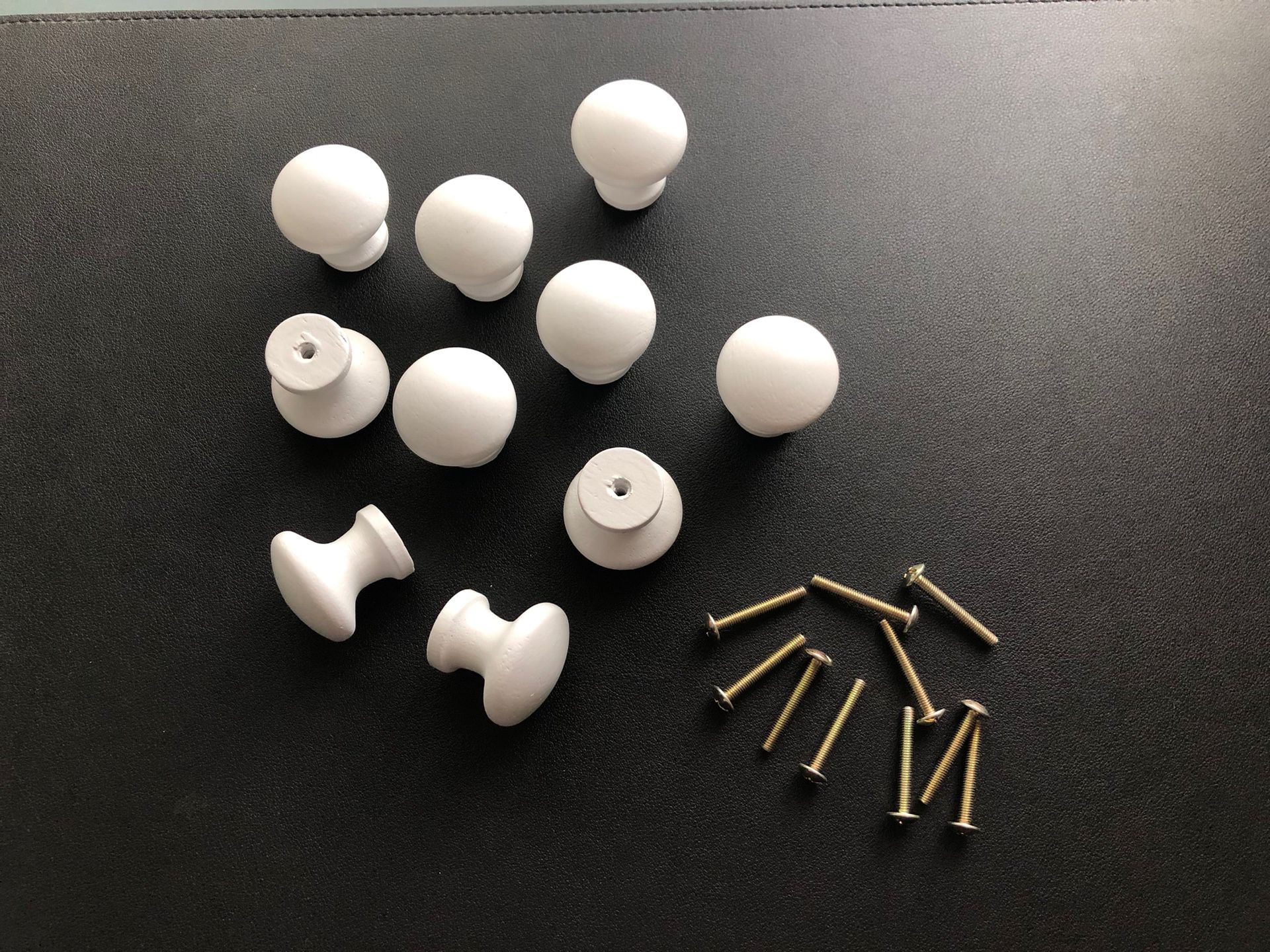 10 White Wooden Dresser Knobs. New condition. Roughly 1 1/2” W/ Hardware