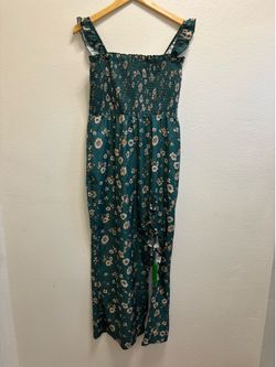 Dark teal ivory print midi dress Medium 100% Rayon print on hem ,side cut outs with strapping ,smocked back ,tie shoulders straps, front slit , front 