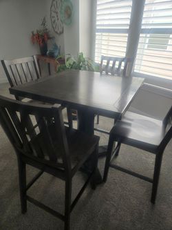 Dining room Table with four chairs. . Bar Height..
