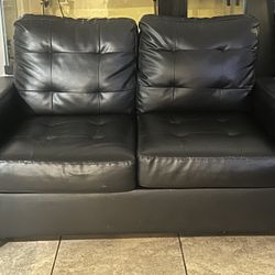 Black leather love seat