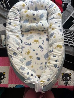 A baby lounger. It’s like a bed for babies.