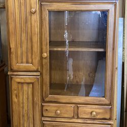 Glass and wood cabinet very sturdy and heavy. Lots of storage.