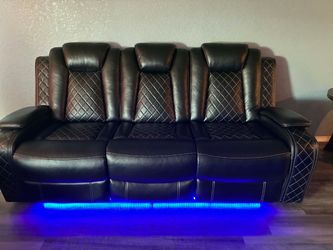Black leather couch’s recliner