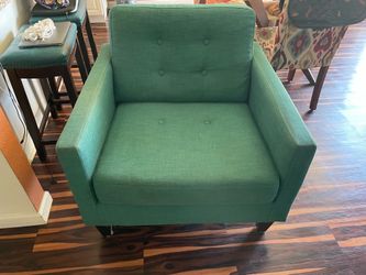 Teal colored chair missing button on seat cushion