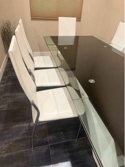 Extendable  table glass dining with the metal frame , great condition , 10 white leather chair