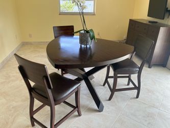 Solid wood dining table with four chairs from City Furniture