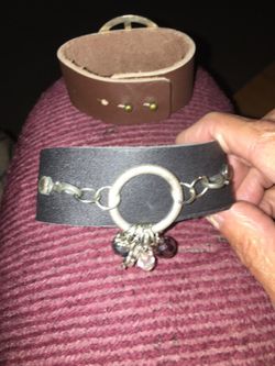 1" wide brown leather bracelet with charms decoration.