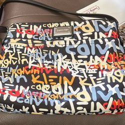 Calvin Klein Shoulder Purse With focus on the outside in the front and the back. Also two pockets inside and a zipper area inside. Very good condition