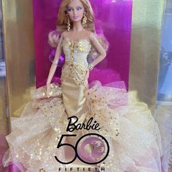 This 50th Anniversary Barbie Gold Glamour Doll is a timeless treasure for collectors and Barbie Doll enthusiasts alike. Designed by Robert Best and ma