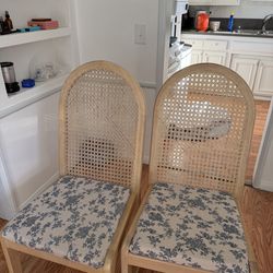 4 rattan dining chairs with blue cushions