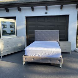 Full size bedroom set, bed covered in fabric with faux diamond stones, with mattress, a nightstand, and dresser with mirror in excellent condition by 