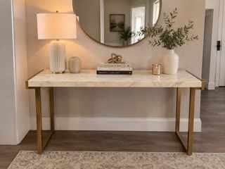 Marble top console with attached gold metal base