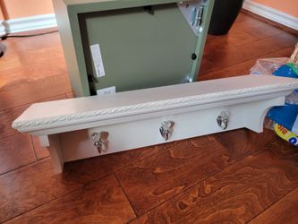 White wood shelf with hooks and gem knows. 2 ft L