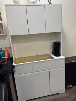 White kitchen pantry cabinet with drawers