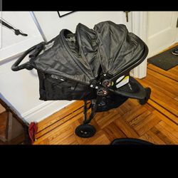 Black Baby Jogger City Mini stroller, car seat base tray and rain cover
