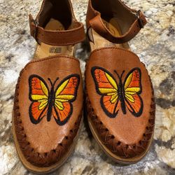  handmade Mexican huarache sandals featuring embroidered butterfly designs