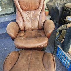 Brown leather chair and ottoman.