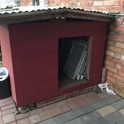 tall dog house with tin roof