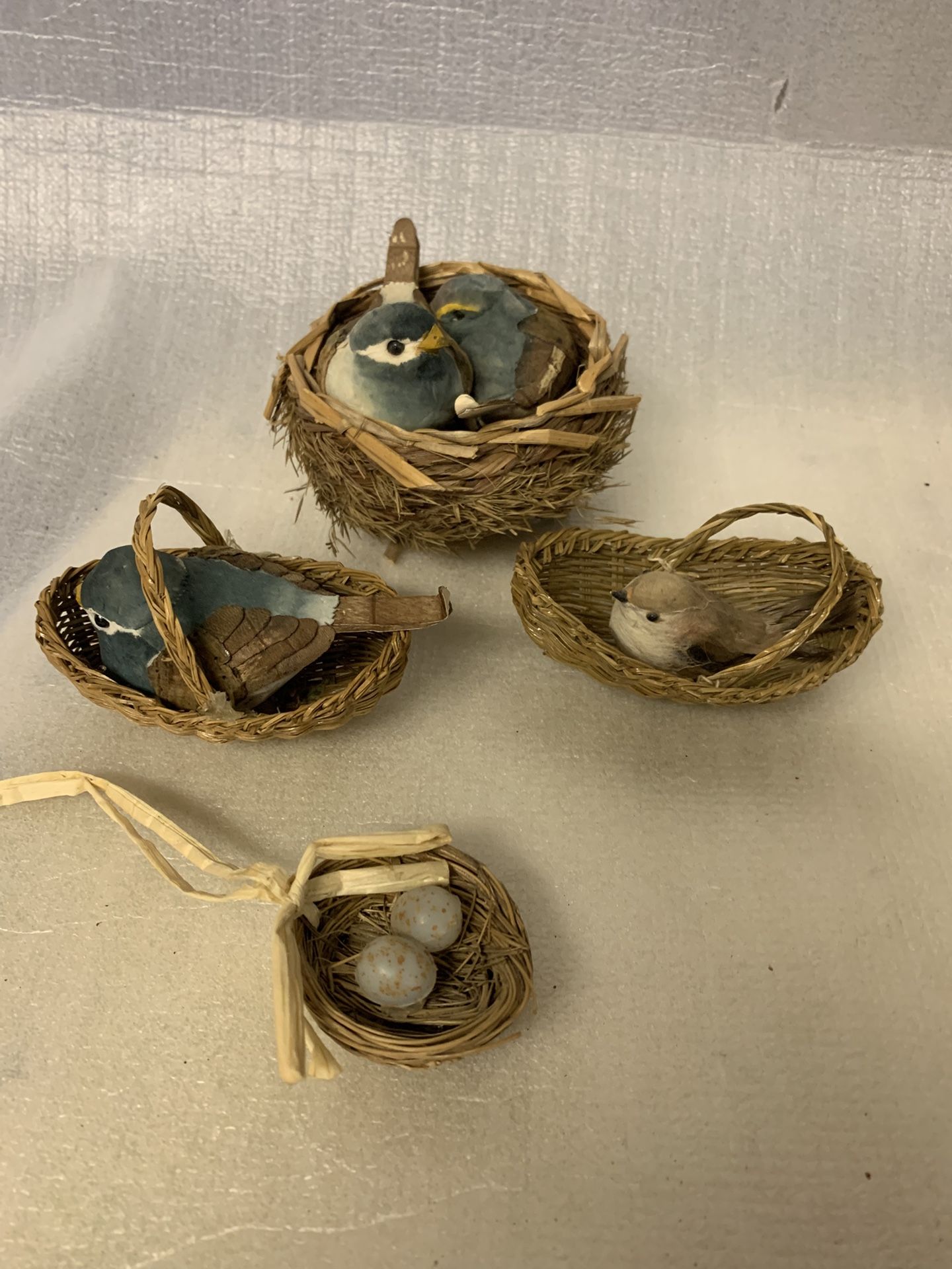 vintage, anthropomorphic bluebird figurines in woven baskets Bird Nests Eggs