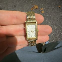 gold-toned vintage Timex Tank quartz watch with a metal bracelet band